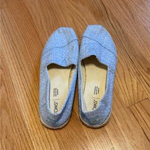 Tom’s blue slip on shoes with white polka dots